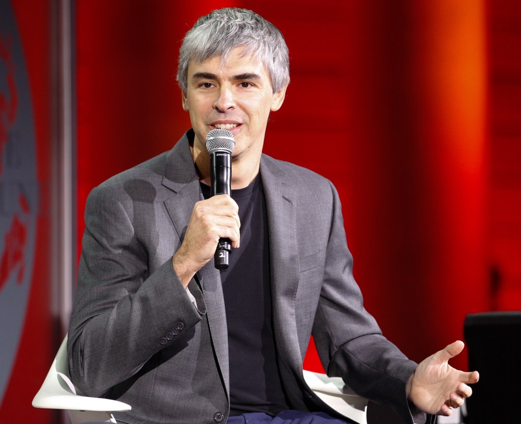 photo of Google cofounder Larry Page speaking into a microphone on a panel