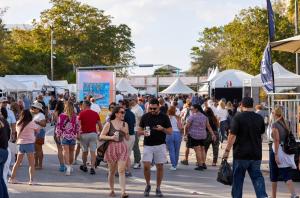 photo of crowds at an outdoor festival with tents