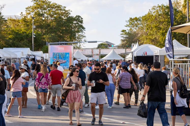 photo of crowds at an outdoor festival with tents