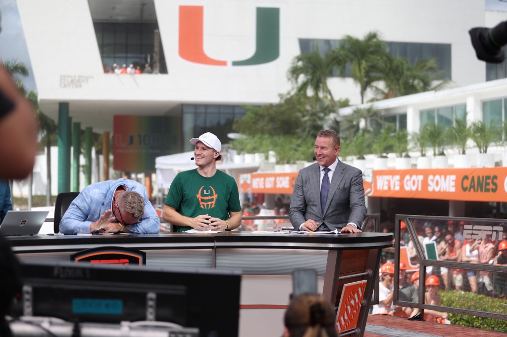 three hosts sit on a sports TV show panel