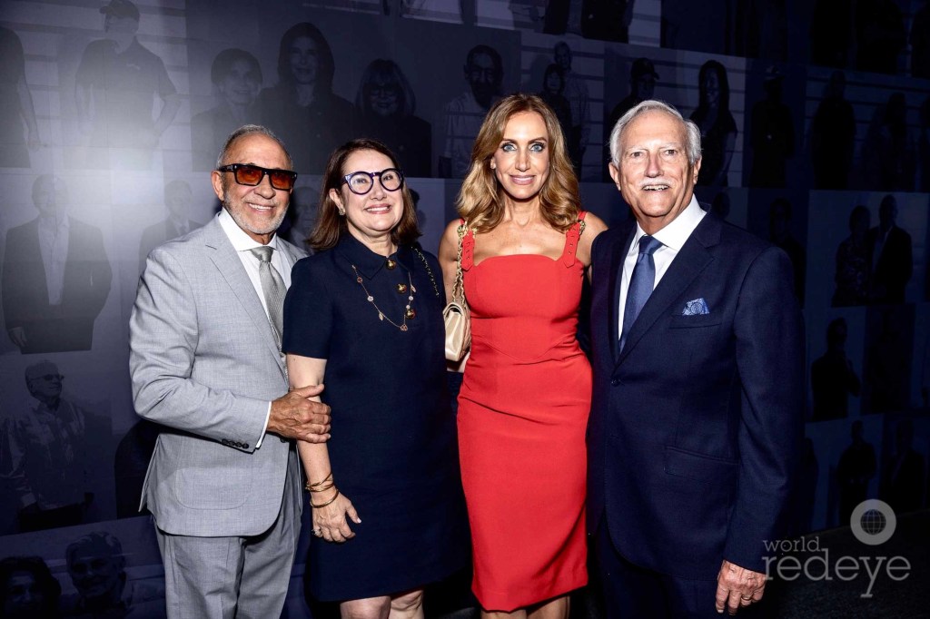 Emilio Estefan, Clara Toro, Lili Estefan, and Mike Bezos pose in front of a museum installation
