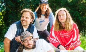 portrait of four mean in a field