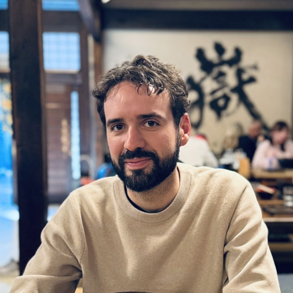headshot of a bearded man in a sweatshirt