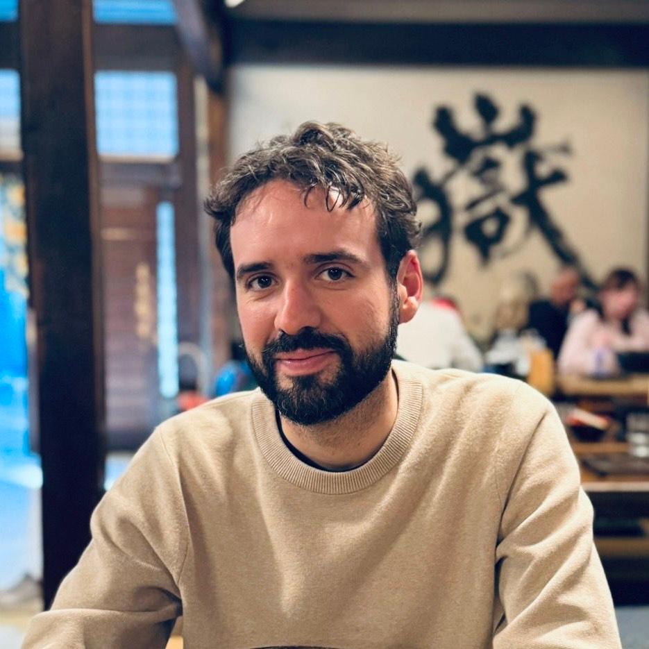 headshot of a bearded man in a sweatshirt