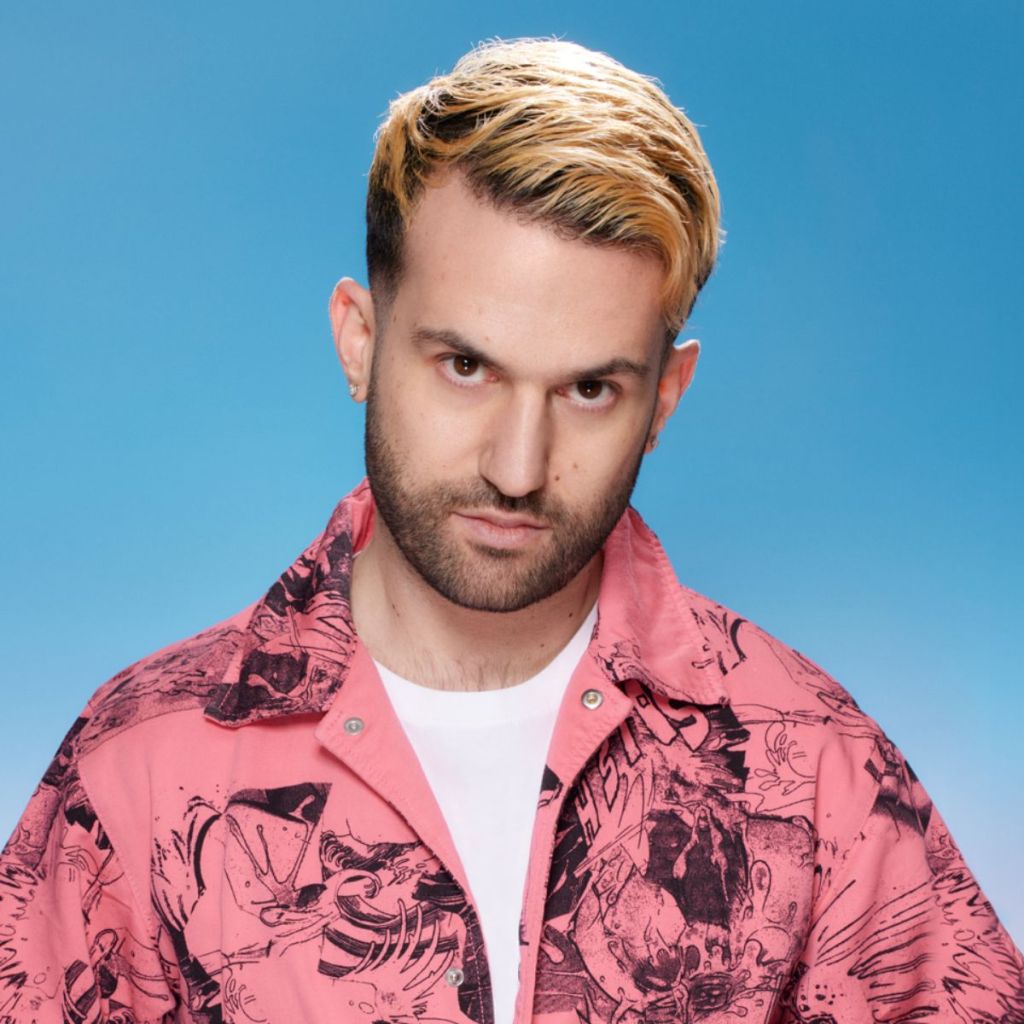 Picture of a man looking at the camera against a light blue background.