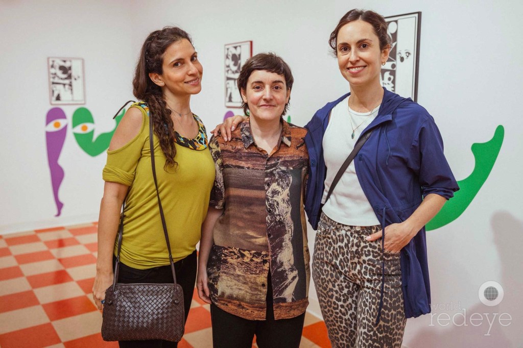 three women posing in an art gallery