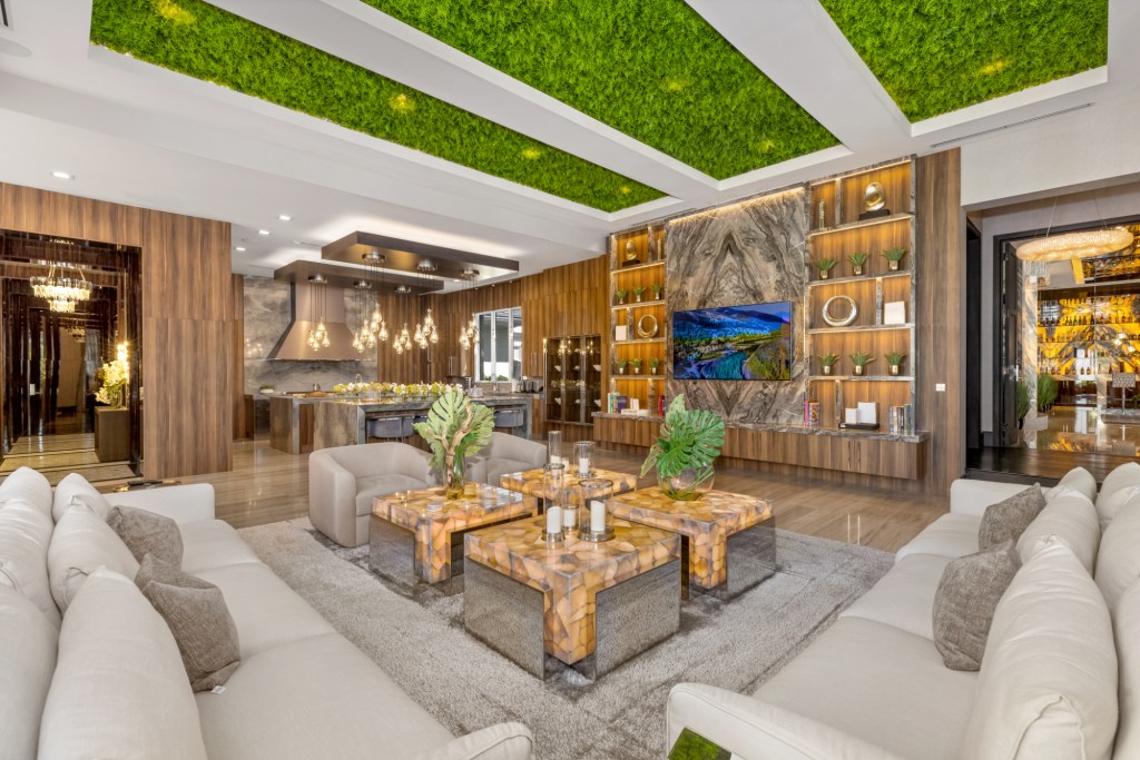 Living room that is designed with turf ceilings, marble and wood features