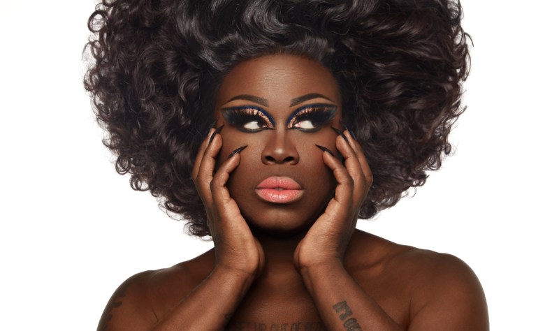 headshot of Bob the Drag Queen wearing an afro and makeup