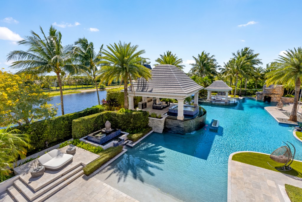 The view of the backyard pool and cabanas
