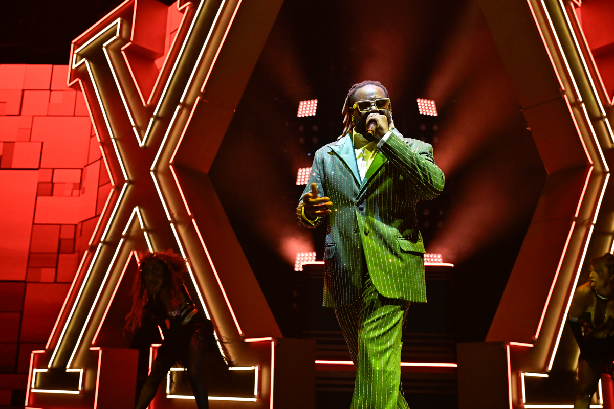 Picture of T-pain singing on stage.