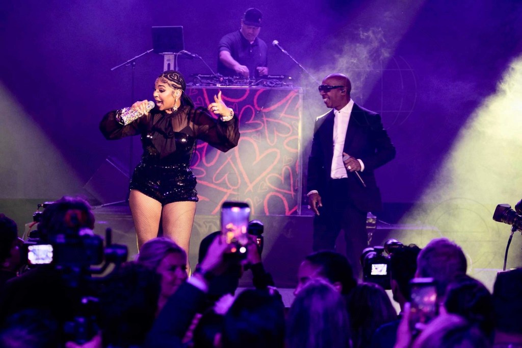 photo of singer Ashanti and rapper Ja Rule performing together on stage with a DJ behind them