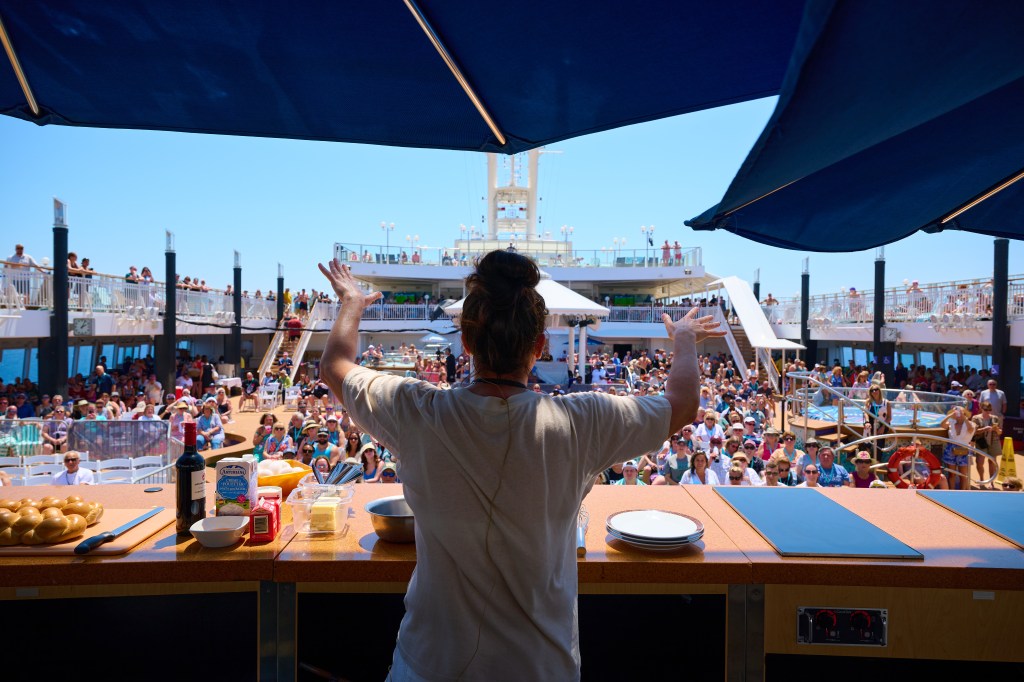 a woman presenting on a cruise ship