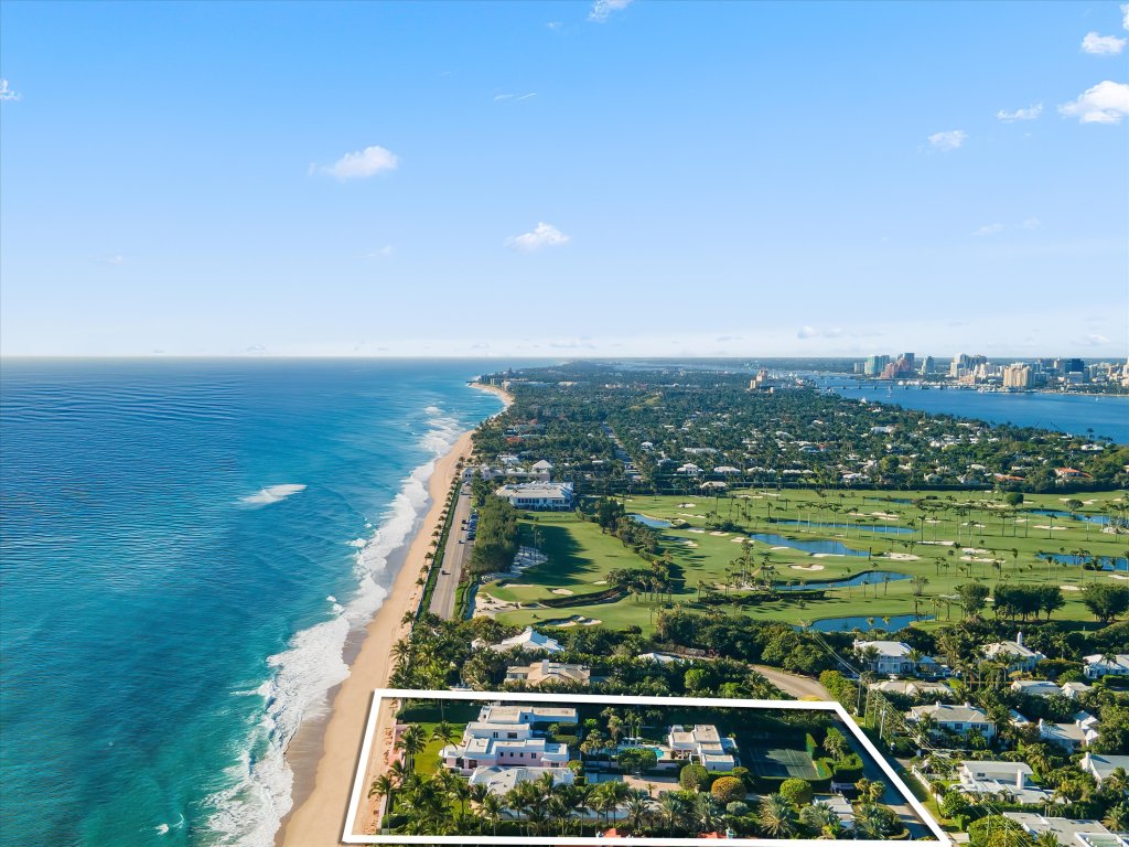 a high aerial shot shows the estate is close to the Palm Beach Country Club and steps away from turquoise ocean water