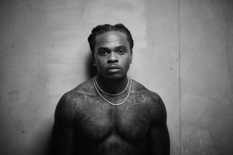 black-and-white photo of rapper Gunna shirtless with two necklaces