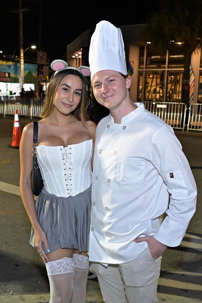 photo of a woman in a corset and mouse ears and a man in a chef's costume