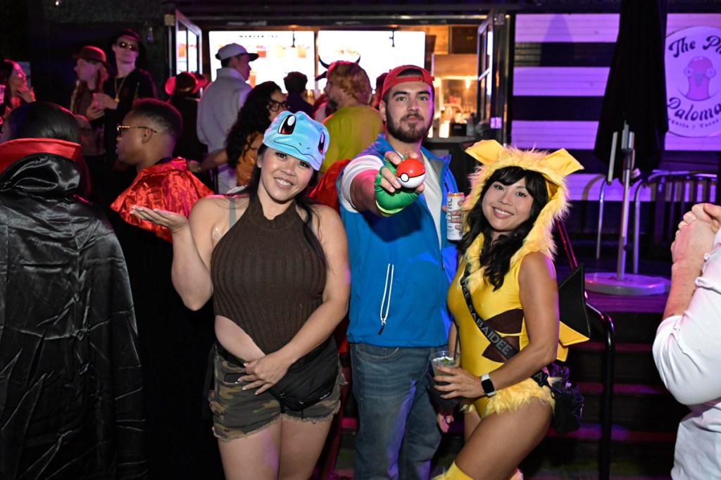 photo of three people dressed in Pokemon costumed for Halloween