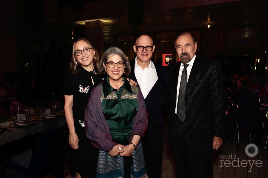 photo of four people posing together at a gala