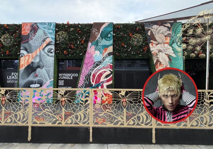 The front of a building covered in graffiti and a portrait of MGK