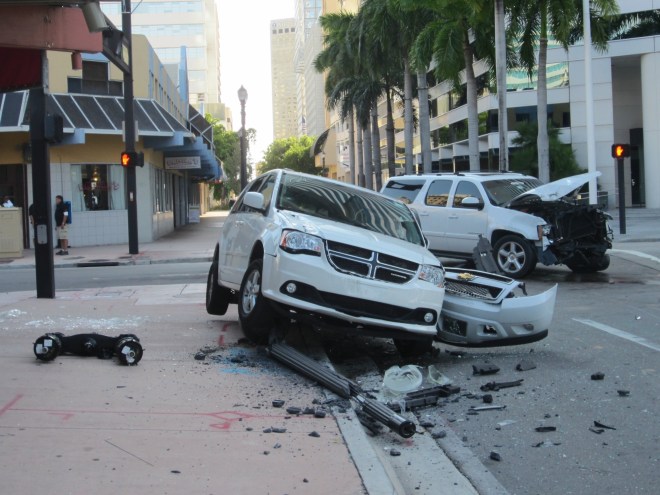 photo of two white SUVs with damage after a car crash in downtown Miami