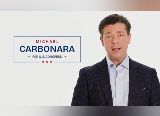 A photo of a white man with brown hair speaking for a campaign ad.