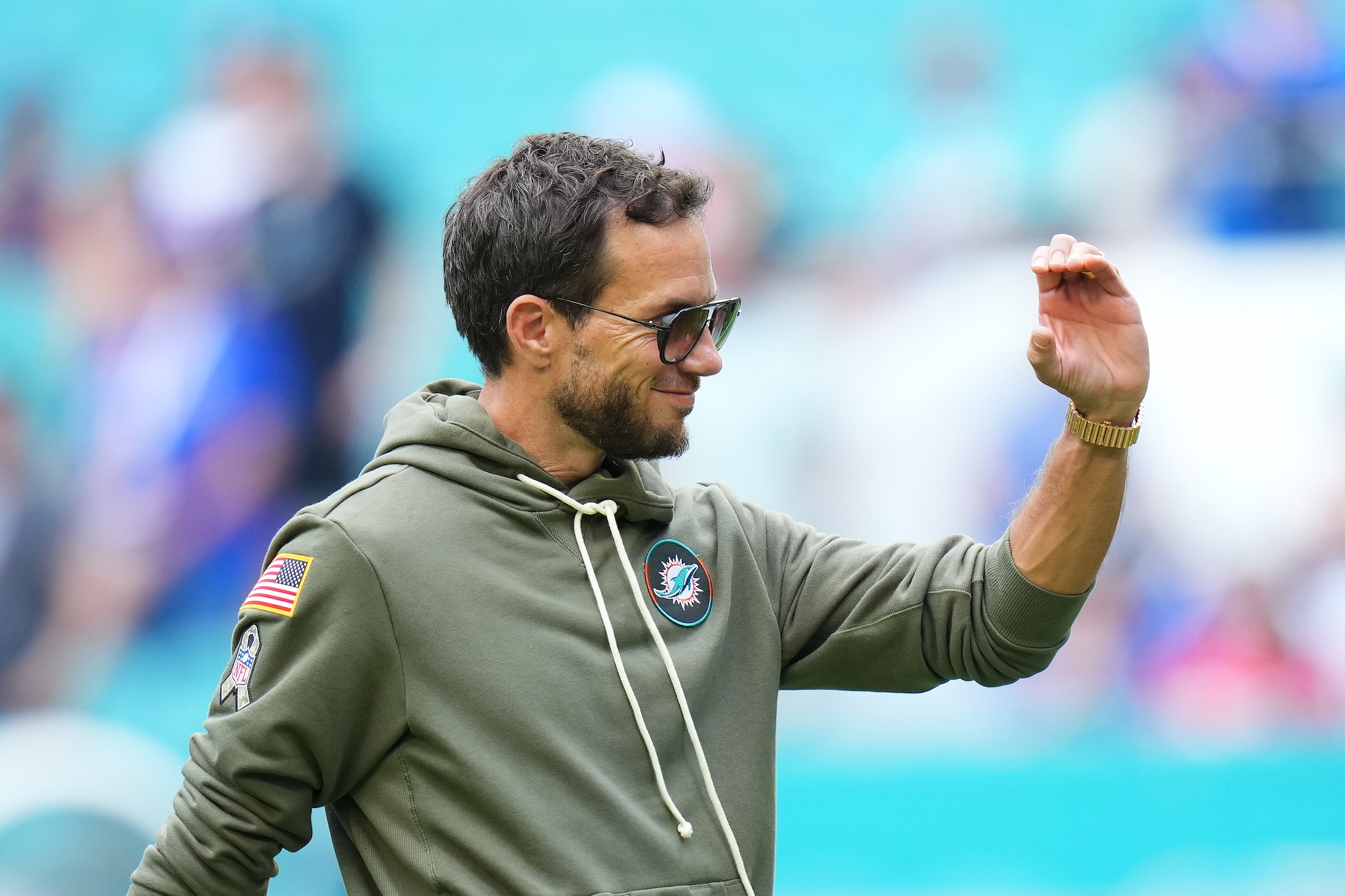 pregame shot of an NFL coach wearing a hoody and looking just a bit cocky
