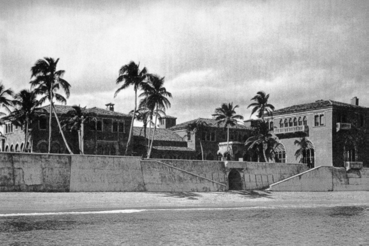 A massive lavish home sits behind seawall