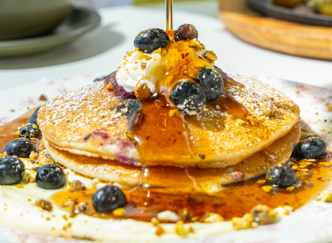 pancakes dripping in maple syrup