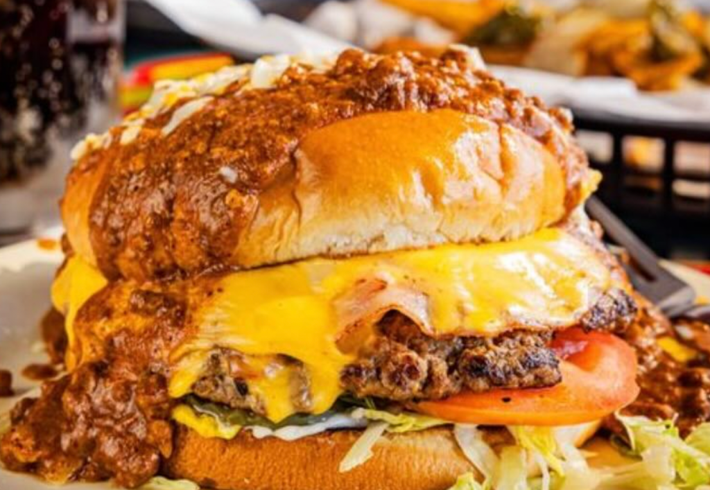 cheeseburger loaded with sauce and toppings