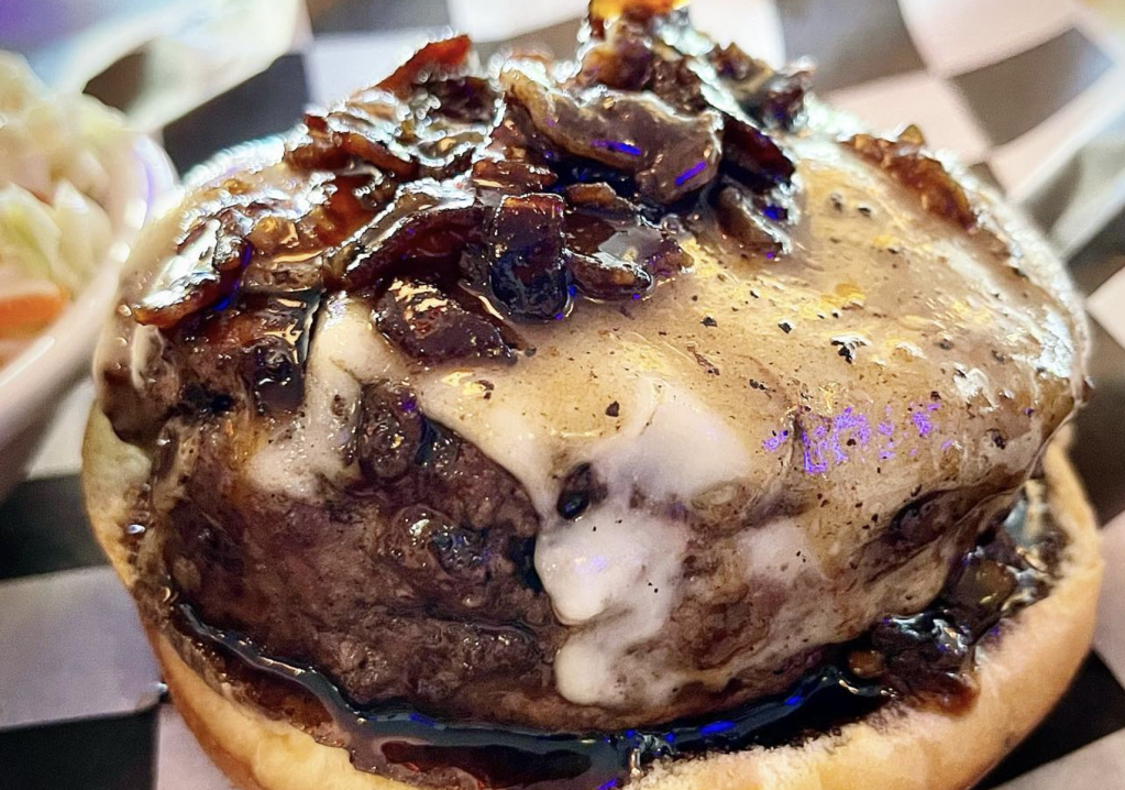 cheeseburger covered in grilled onions