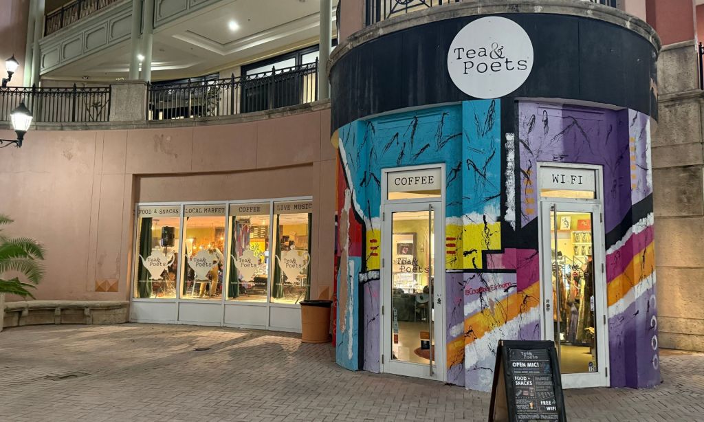 Photo of the front of a building with a sign that reads tea and poets.