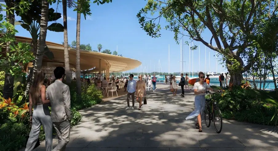 people outside dining and walking by the water