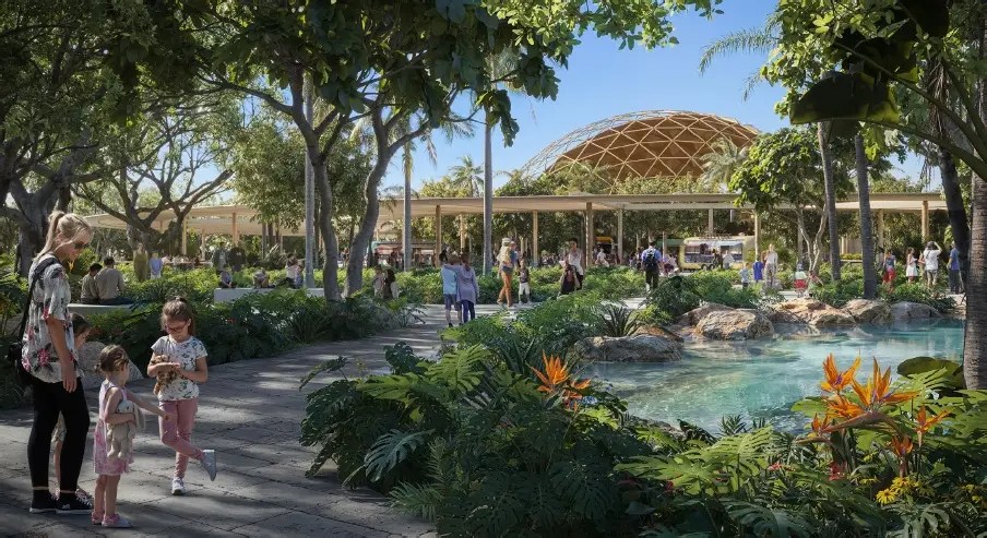 a woman and child walking into the aquarium building