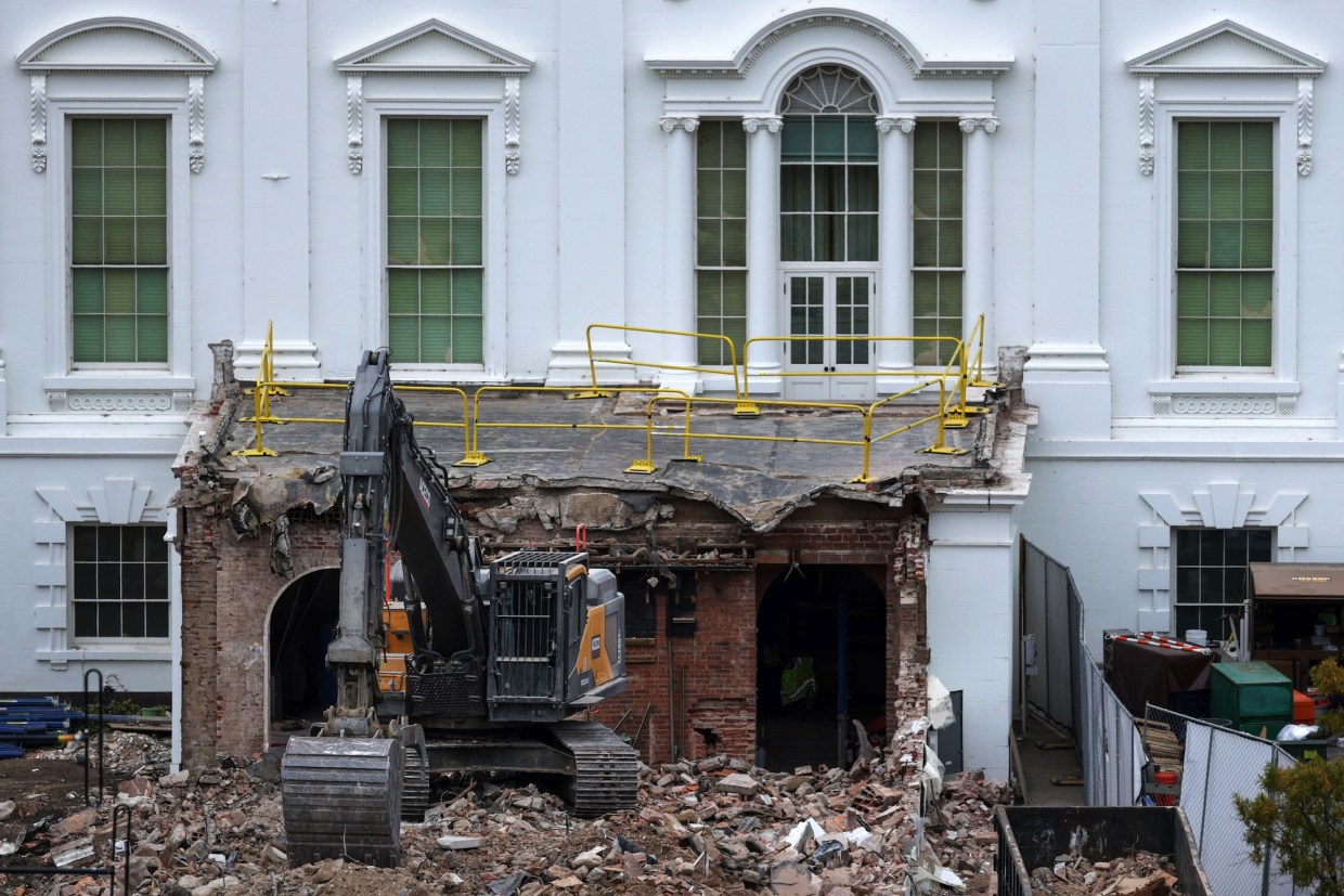 An excavator sits on the rubble after the East Wing of the White House was demolished on October 28, 2025, in Washington, D.C. The demolition is part of Donald Trump's plan to build a ballroom on the eastern side of the White House.