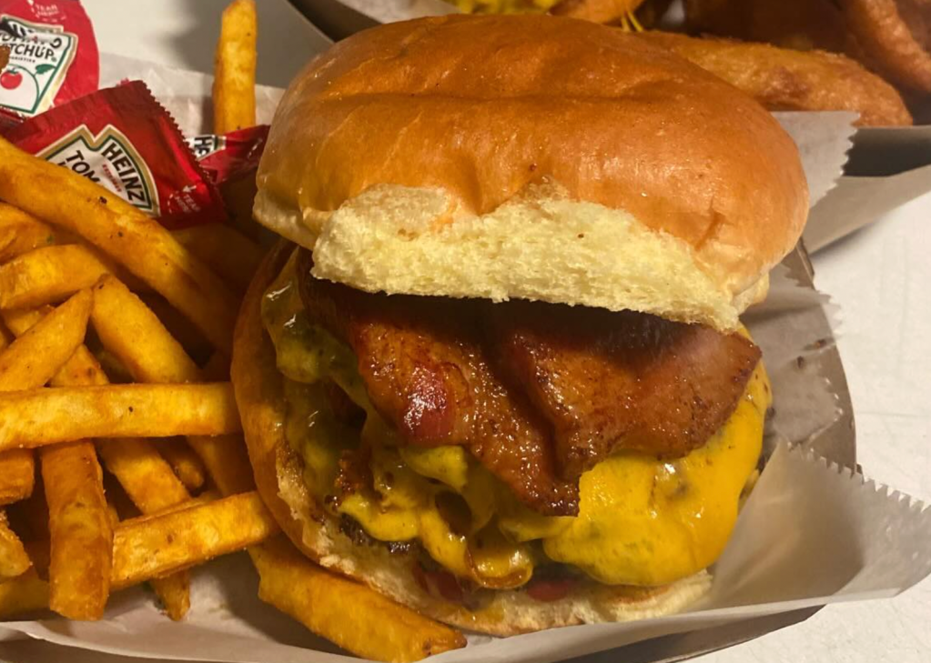 a bacon cheeseburger with a side of fries
