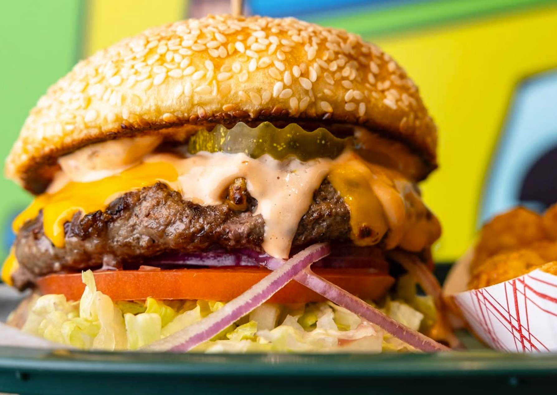 a cheeseburger with special sauce on a fun backgroud