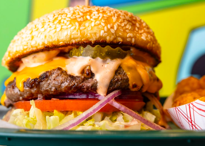 a cheeseburger with special sauce on a fun backgroud