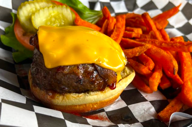 cheeseburger next to sweet potato fries