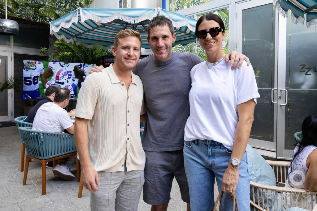 photo of three people posing at an outdoor restaurant