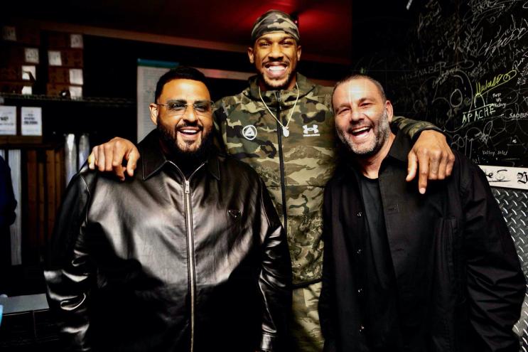 photo of DJ Khaled, Anthony Joshua and David Grutman posing together at a club