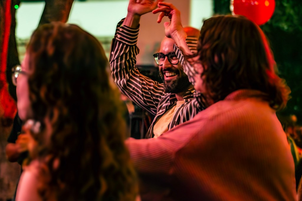 Photo of a crowd sitting in front of a stage.