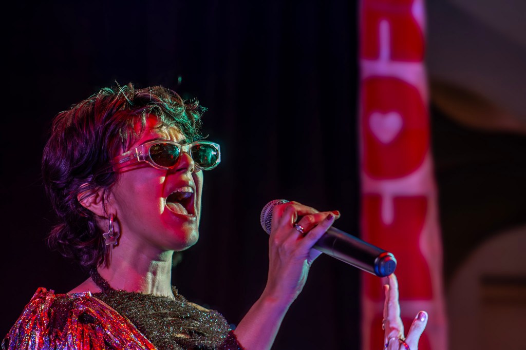 Photo of a woman singing with a microphone