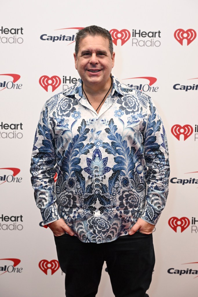 Photo of a man wearing a white and blue shirt. 