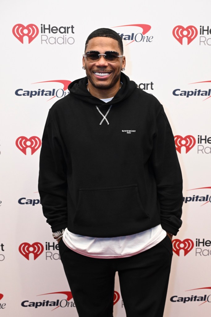 Photo of a man wearing black glasses and a hoodie. 