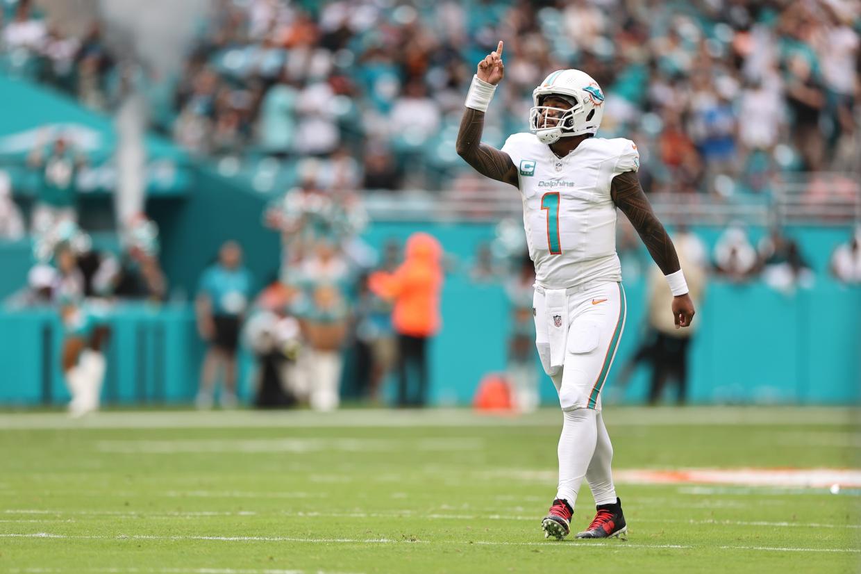 Miami Dolphins quarterback Tua Tagovailoa on the field at Hard Rock Stadium, holding up one finger after a Dolphins touchdown