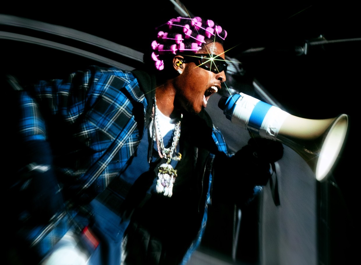 Photo of a man screaming at a megaphone