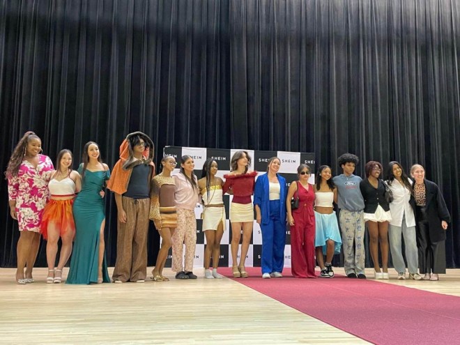Photo of students standing on a stage in an auditorium