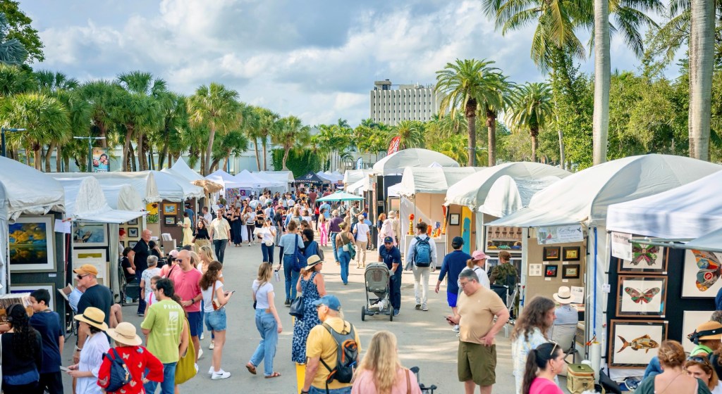 photo of people walking among tents at an outdoor arts festival