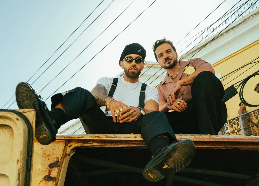 Two men on top of a van