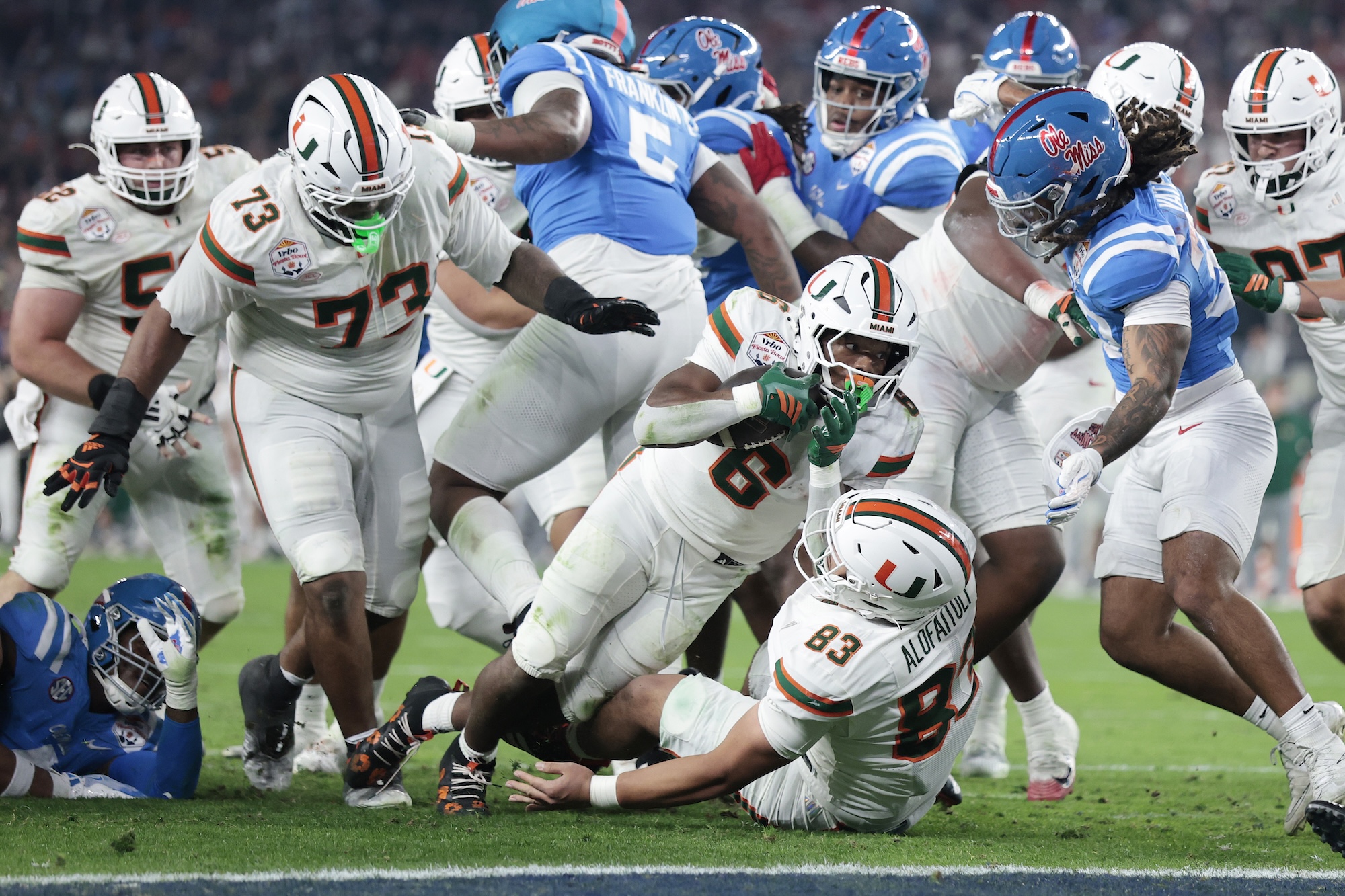 CharMar Brown #6 of the Miami Hurricanes carries the ball for a touchdown, diving against the Ole Miss.