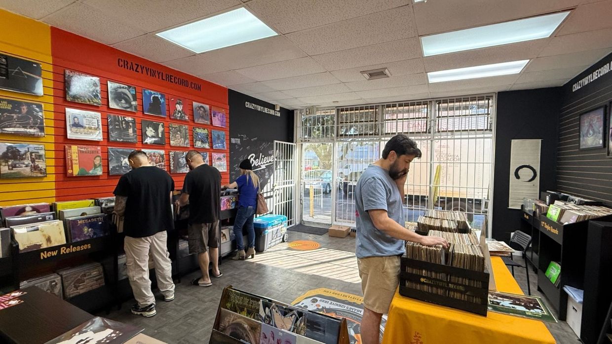 People at a store digging through vinyl